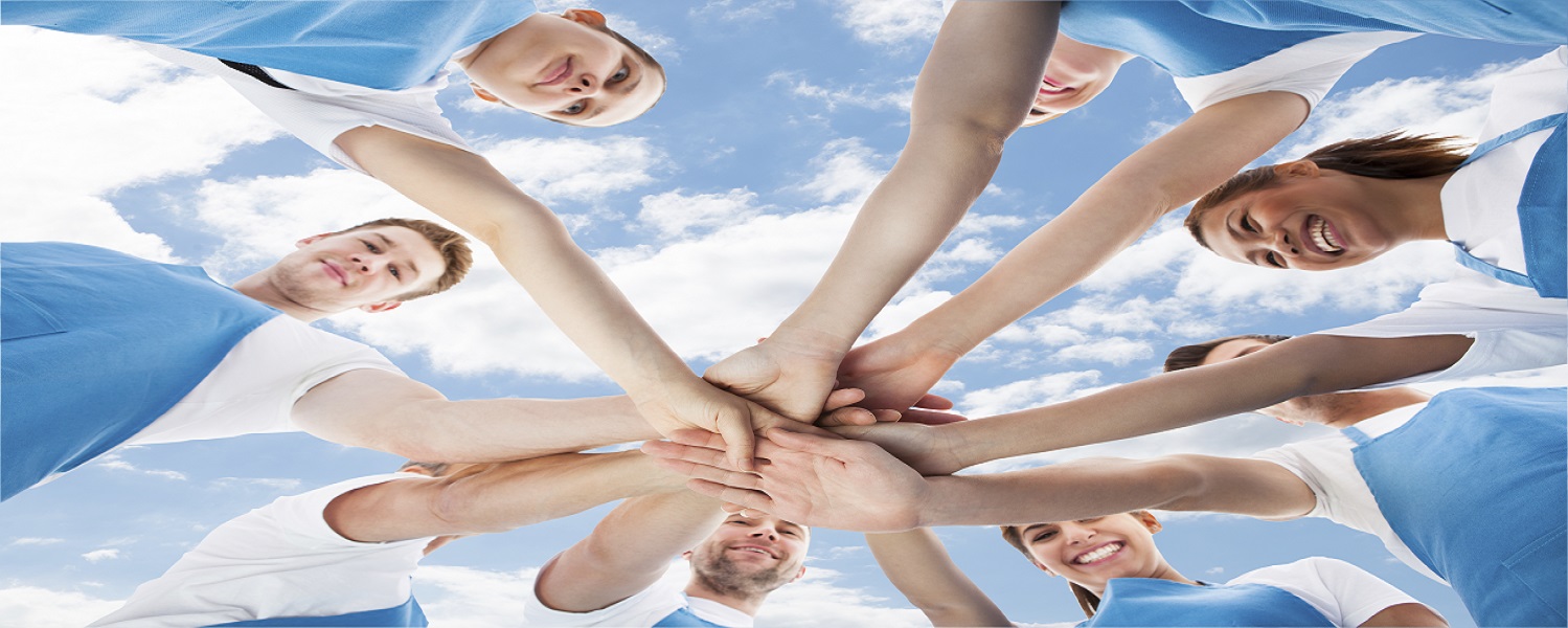 Professional Cleaners Piling Hands Against Sky